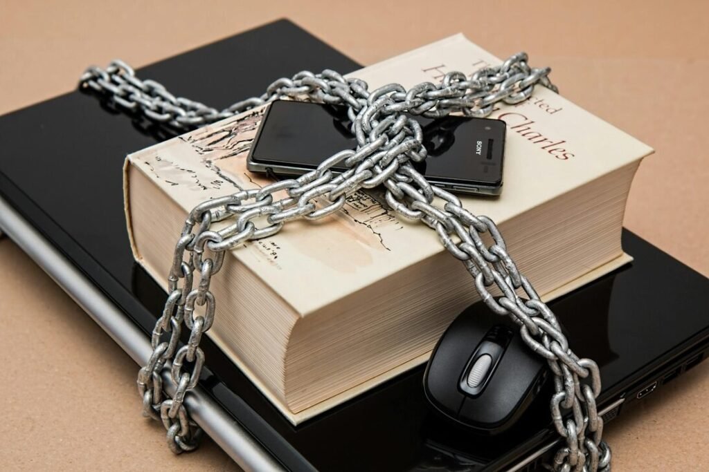 A chained book representing cyber security, accompanied by a mouse, illustrating the theme of digital protection and threats.